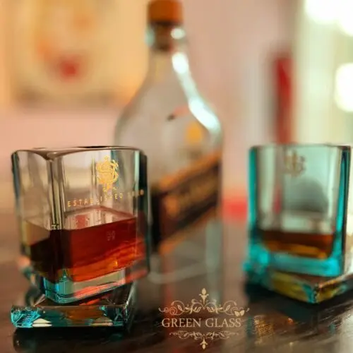 Lanchi hand-sculpting a Johnnie Walker Blue Label bottle into a bespoke Extreme II whisky glass | Green Glass Artisan Studio